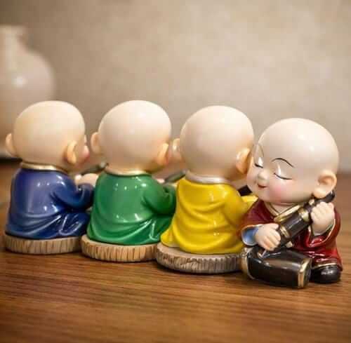 set of 4 smiling monk figurines colorful ceramic buddhist home decor showpieces India smiling monk figurines set for home decor India