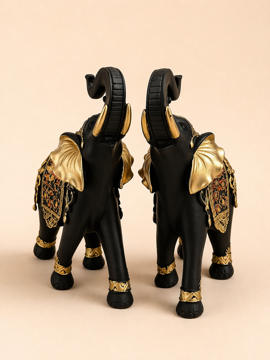 Black And Gold Elephant Statue Set showcasing intricate details and luxurious textures for home decor.